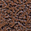 Close-up texture of small brown granules and chips, coarse gritty surface
